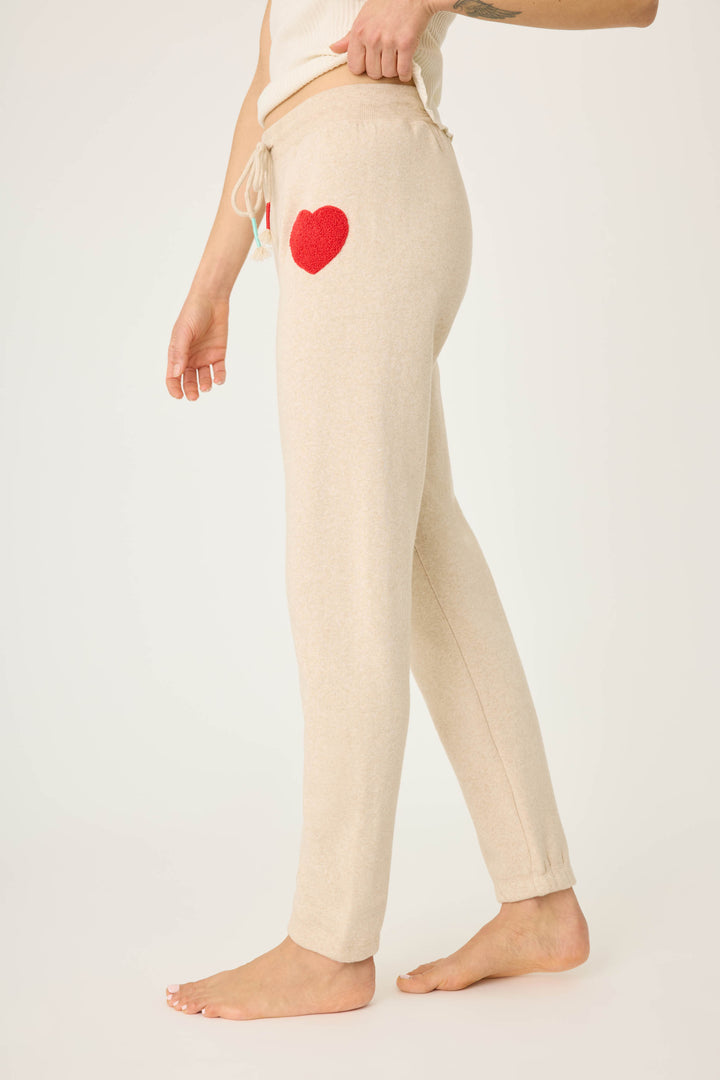Women's oatmeal jogger pant with red boucle heart applique. Oatmeal cloud terry with tie waist.