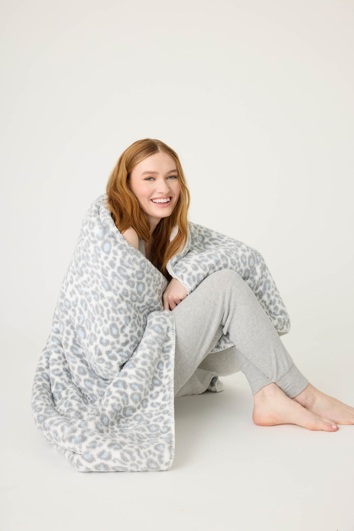 Reversible blanket in grey-white leopard print. Personal size blanket with carry strap.