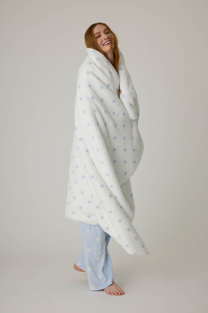 Reversible blanket in ivory polka dot print. Personal size blanket with carry strap.