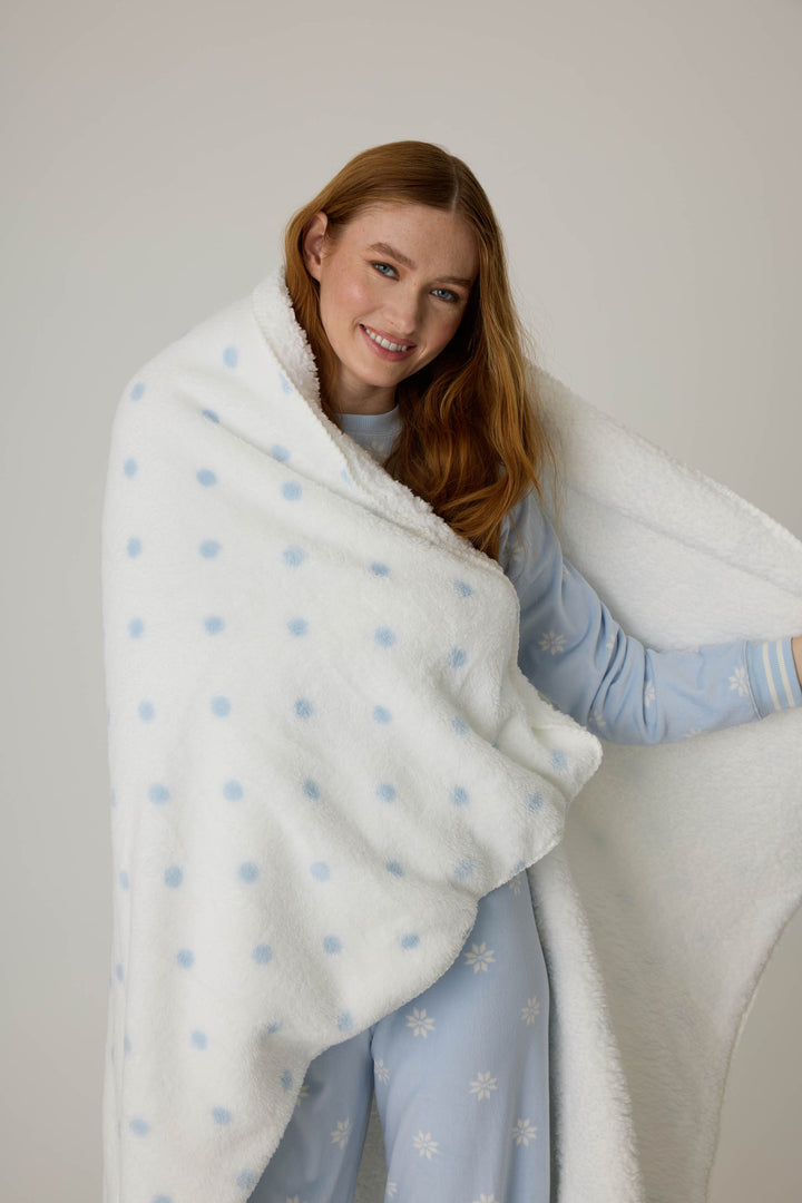 Reversible blanket in ivory polka dot print. Personal size blanket with carry strap.