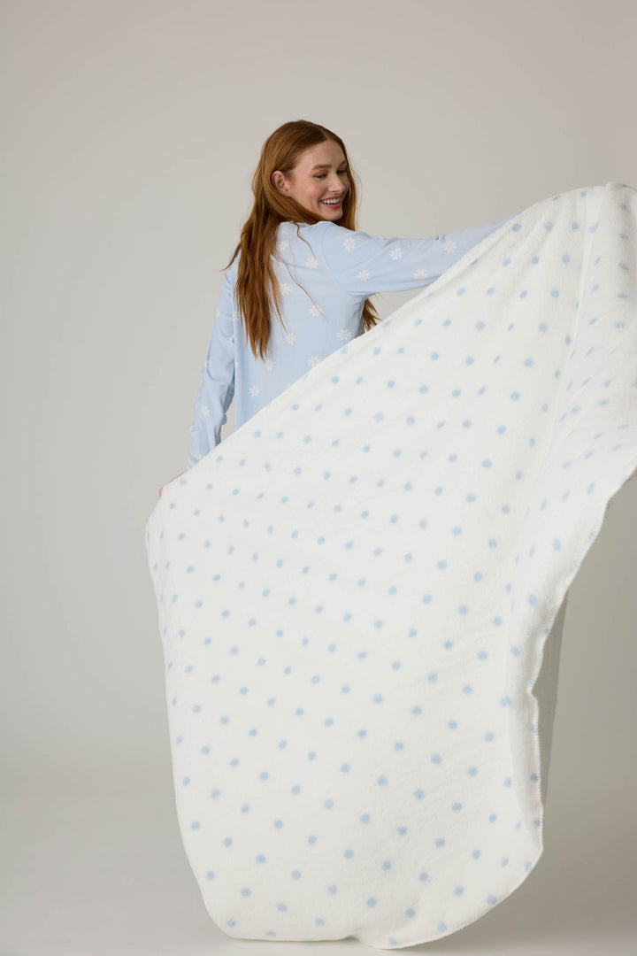 Reversible blanket in ivory polka dot print. Personal size blanket with carry strap.