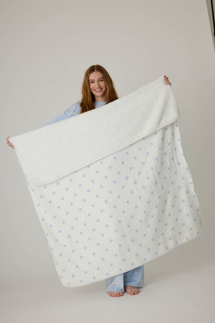 Reversible blanket in ivory polka dot print. Personal size blanket with carry strap.