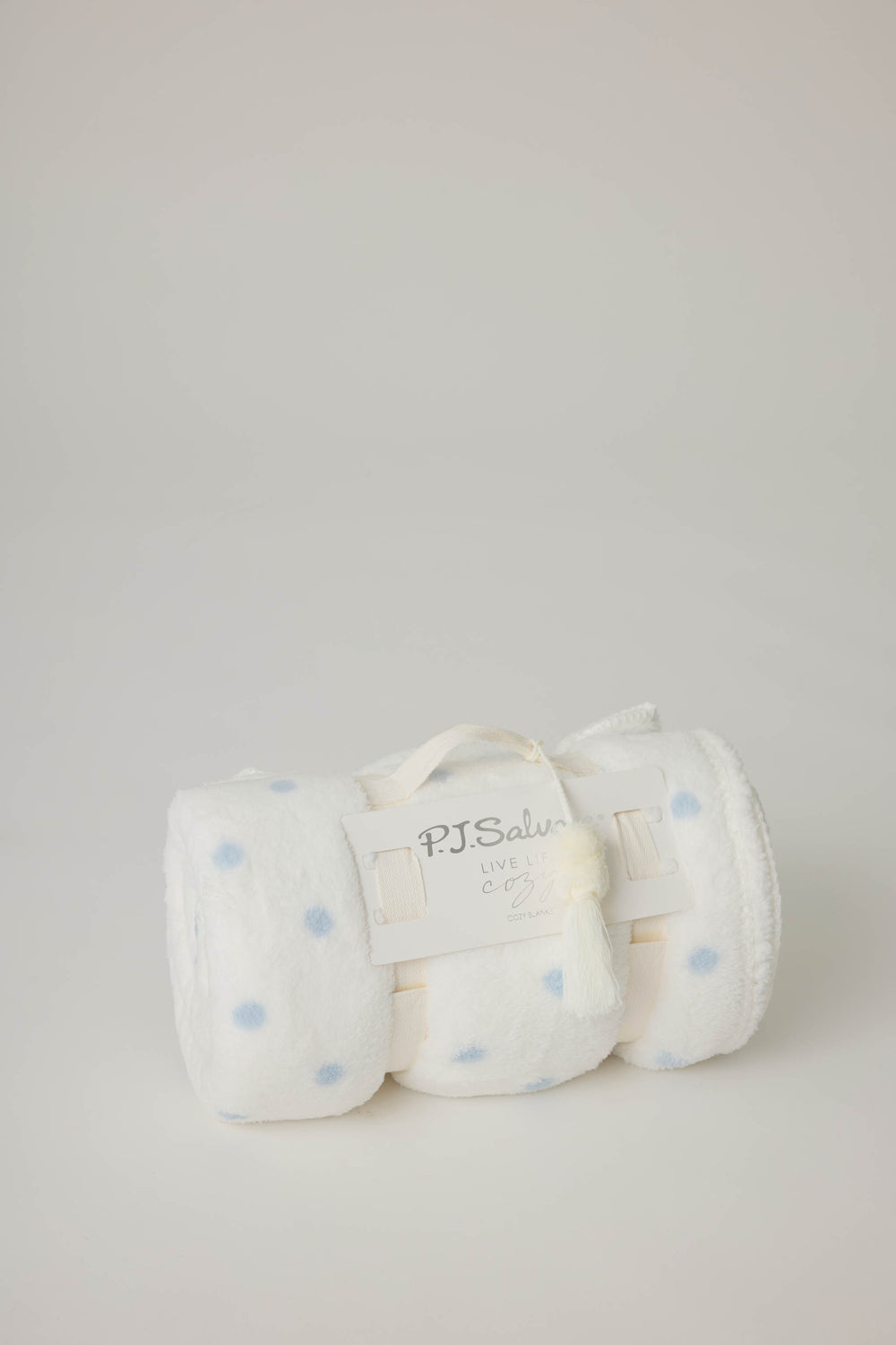 Reversible blanket in ivory polka dot print. Personal size blanket with carry strap.