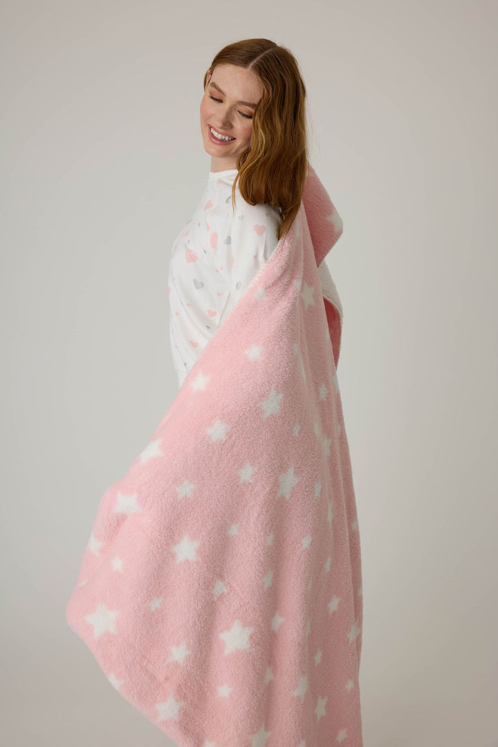 Reversible blanket in pink-white star print. Personal size blanket with carry strap.