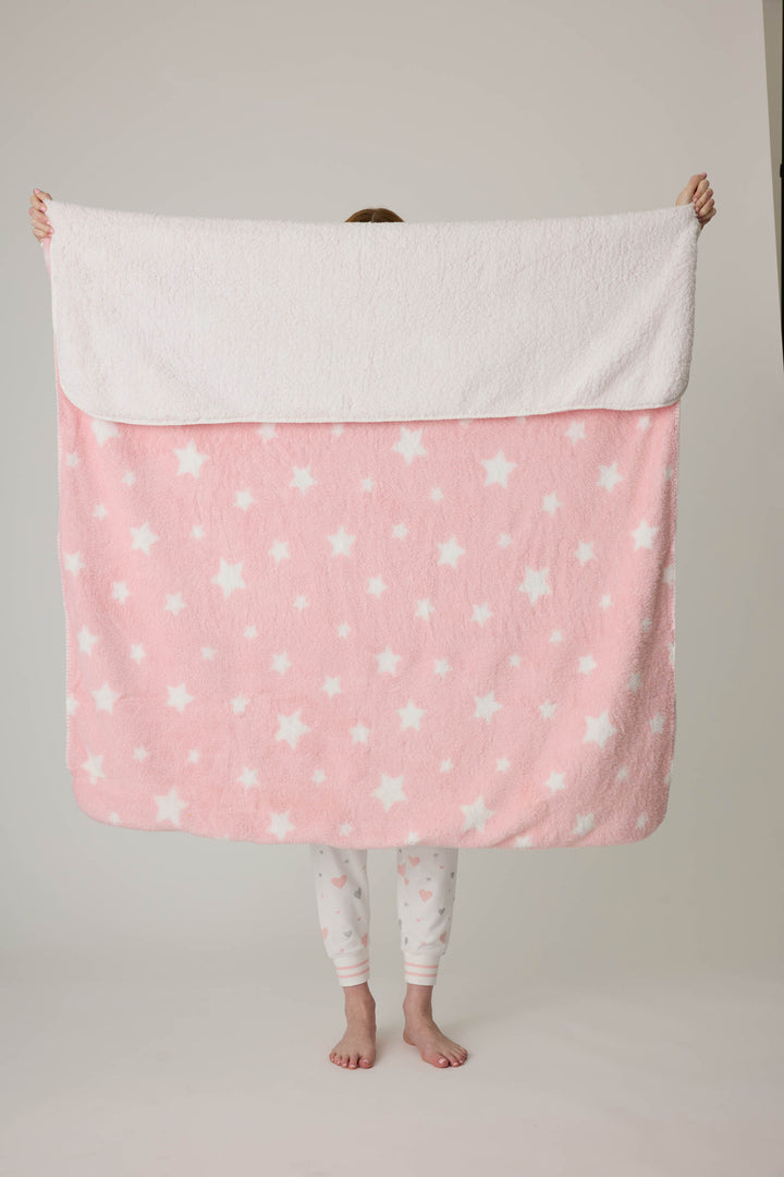 Reversible blanket in pink-white star print. Personal size blanket with carry strap.