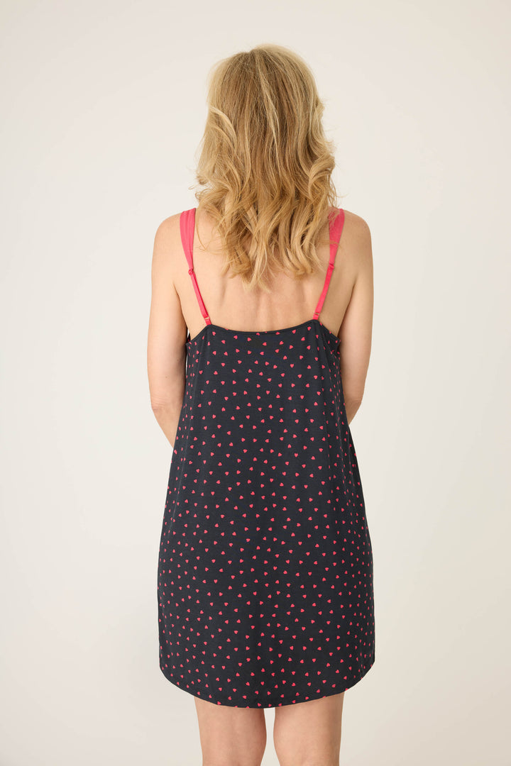 Women's black sleep chemise with shelf bra, adjustable straps and pink heart pattern.