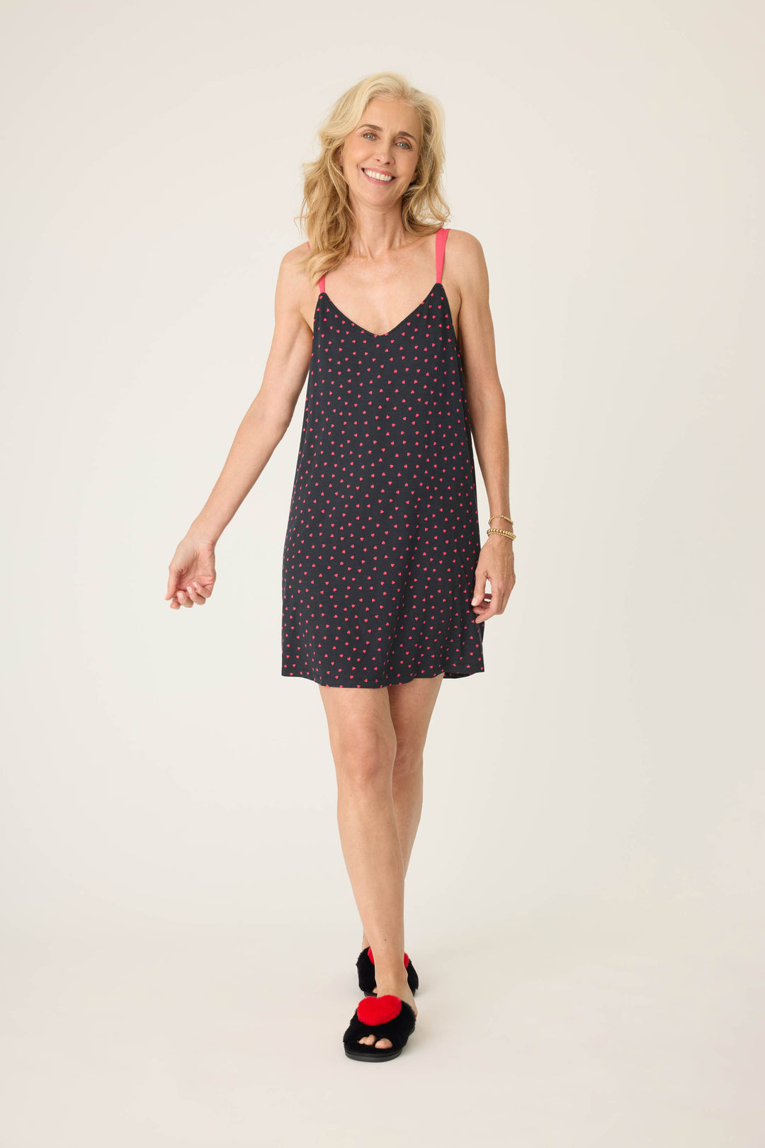 Women's black sleep chemise with shelf bra, adjustable straps and pink heart pattern.