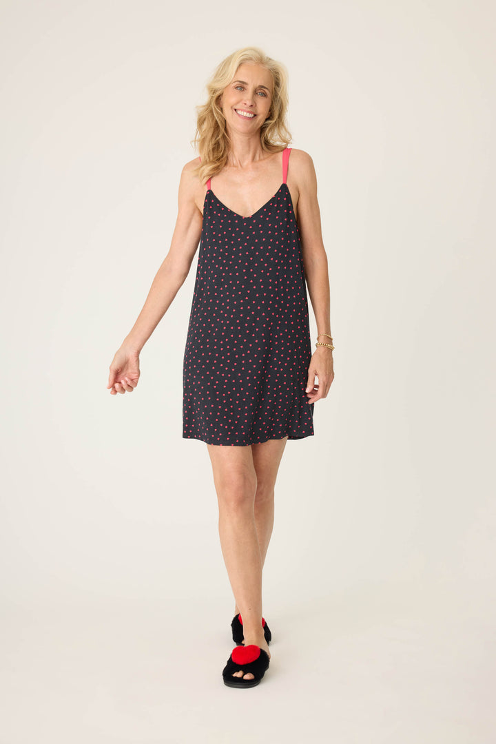 Women's black sleep chemise with shelf bra, adjustable straps and pink heart pattern.