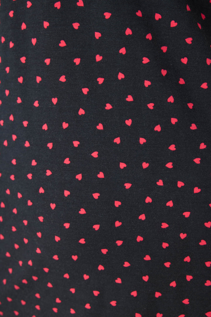 Women's black sleep chemise with shelf bra, adjustable straps and pink heart pattern.