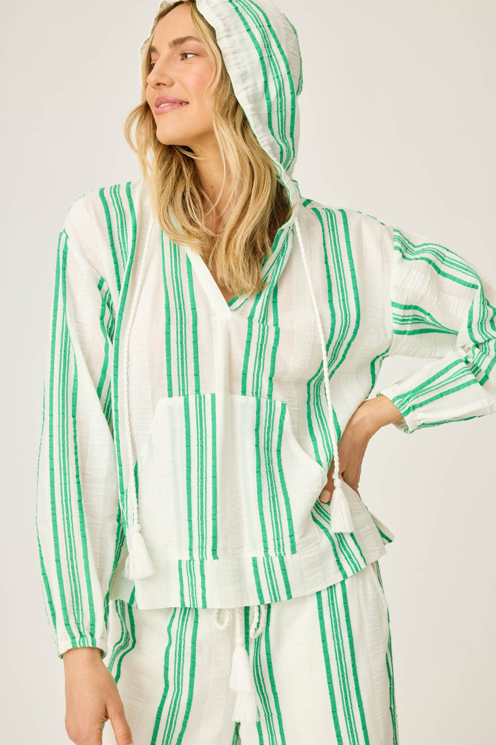 Women's green & white striped pullover V-neck hoody in cotton woven gauze. With front pocket & gathered sleeve cuffs.