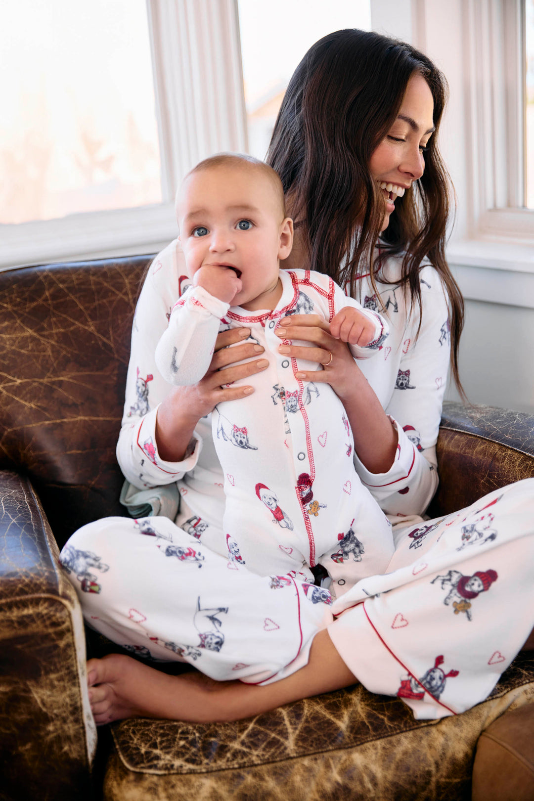 Infant's white romper with holiday dog with red hats pattern.