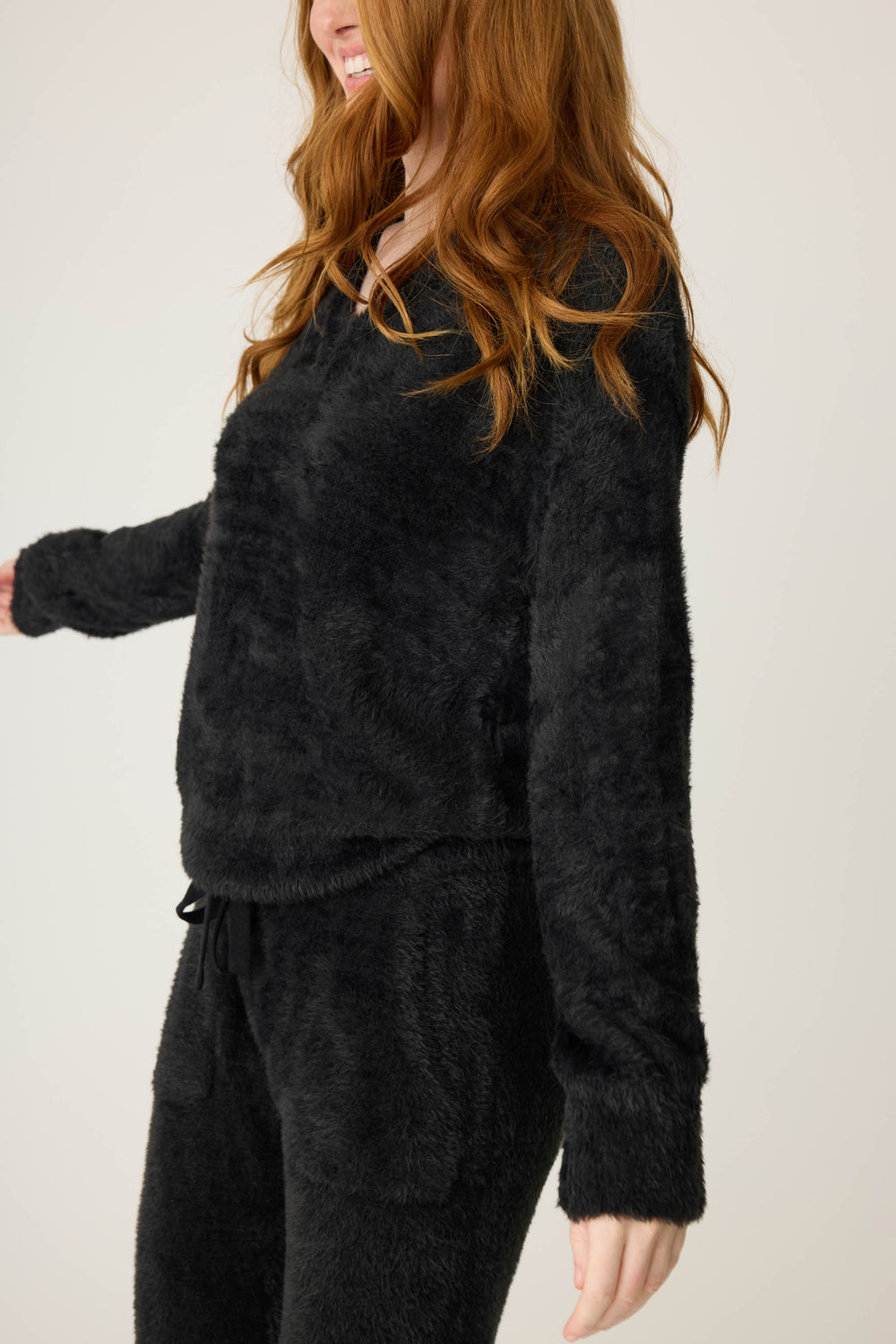 Women's black feather knit long sleeve top.