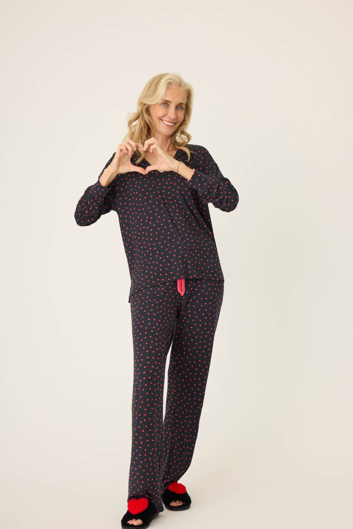 Women's black long sleeve pj top with pink heart pattern.