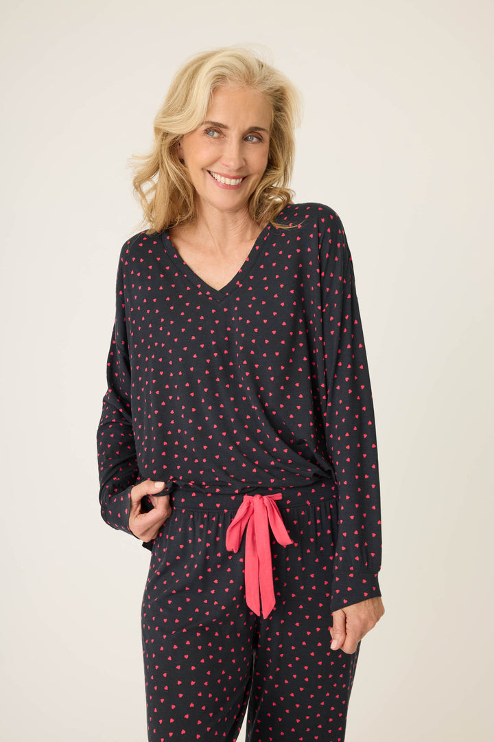 Women's black long sleeve pj top with pink heart pattern.