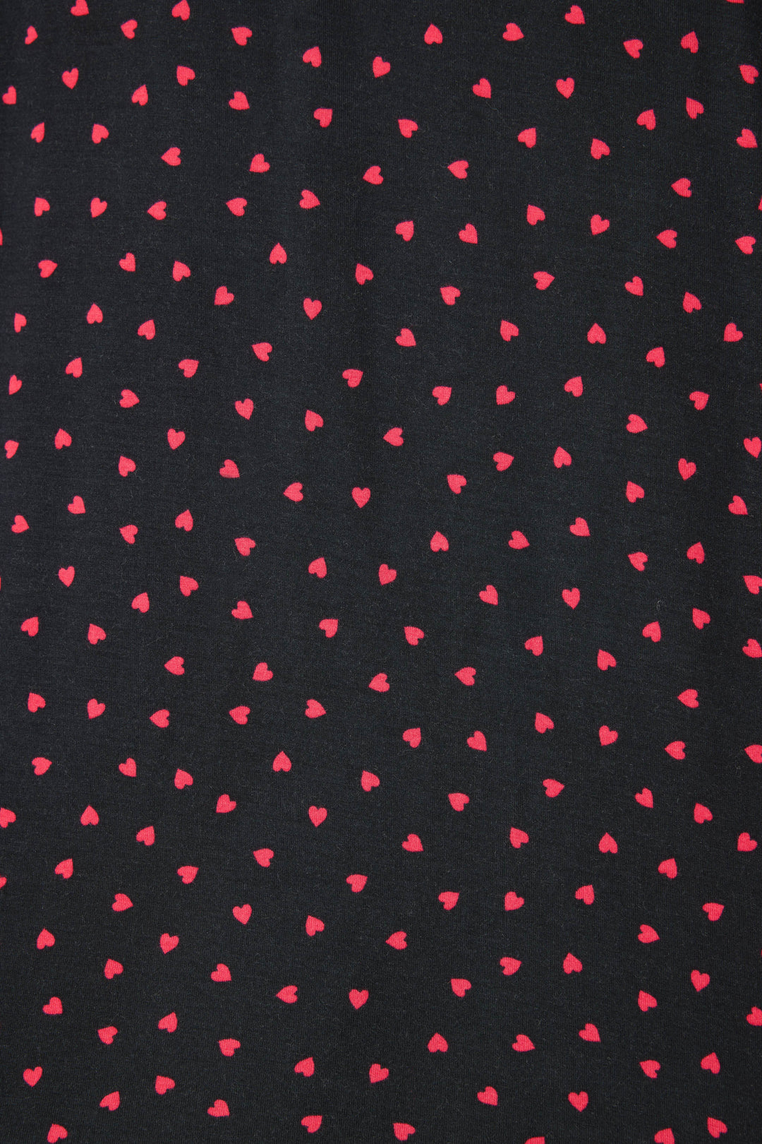 Women's black long sleeve pj top with pink heart pattern.