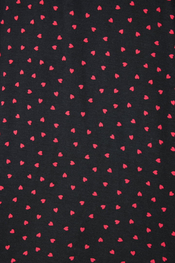 Women's black long sleeve pj top with pink heart pattern.