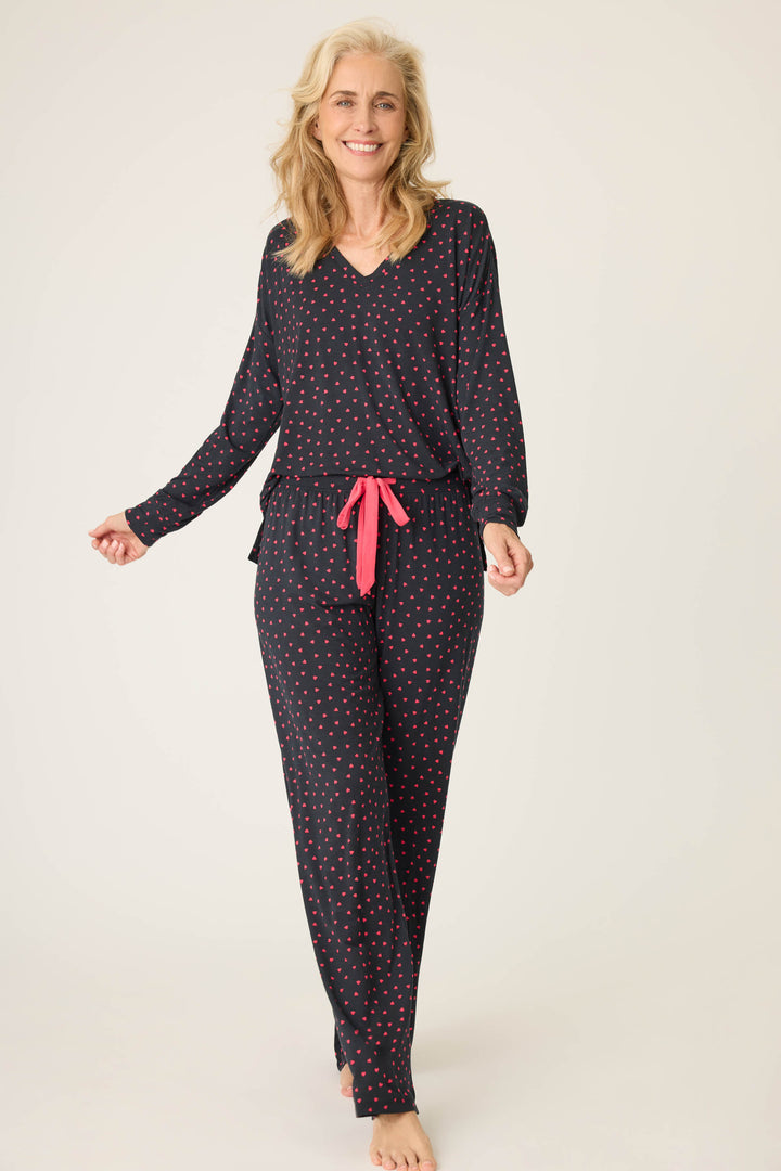 Women's black long sleeve pj top with pink heart pattern.