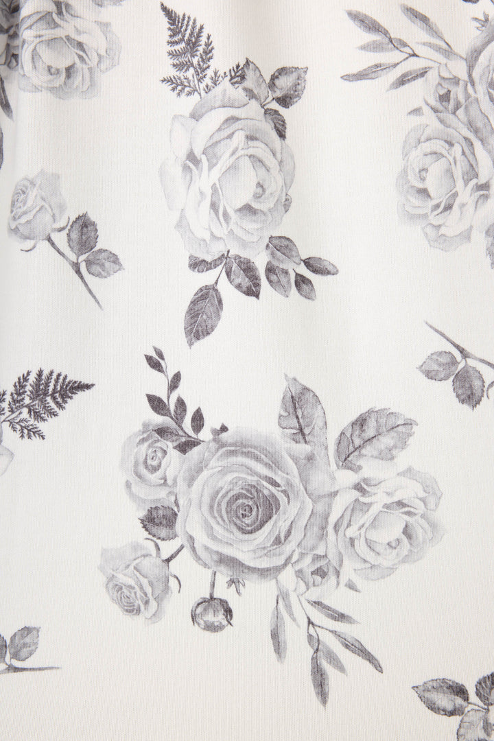 Women's white pj top with black rose design. 