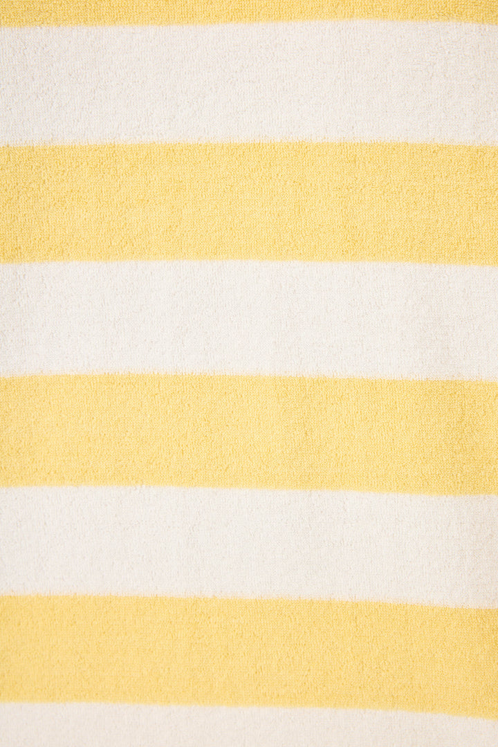 Ivory-yellow terry stripe with blue PARADISE embroidery on front. Long sleeve with elastic hem, sits at waist.