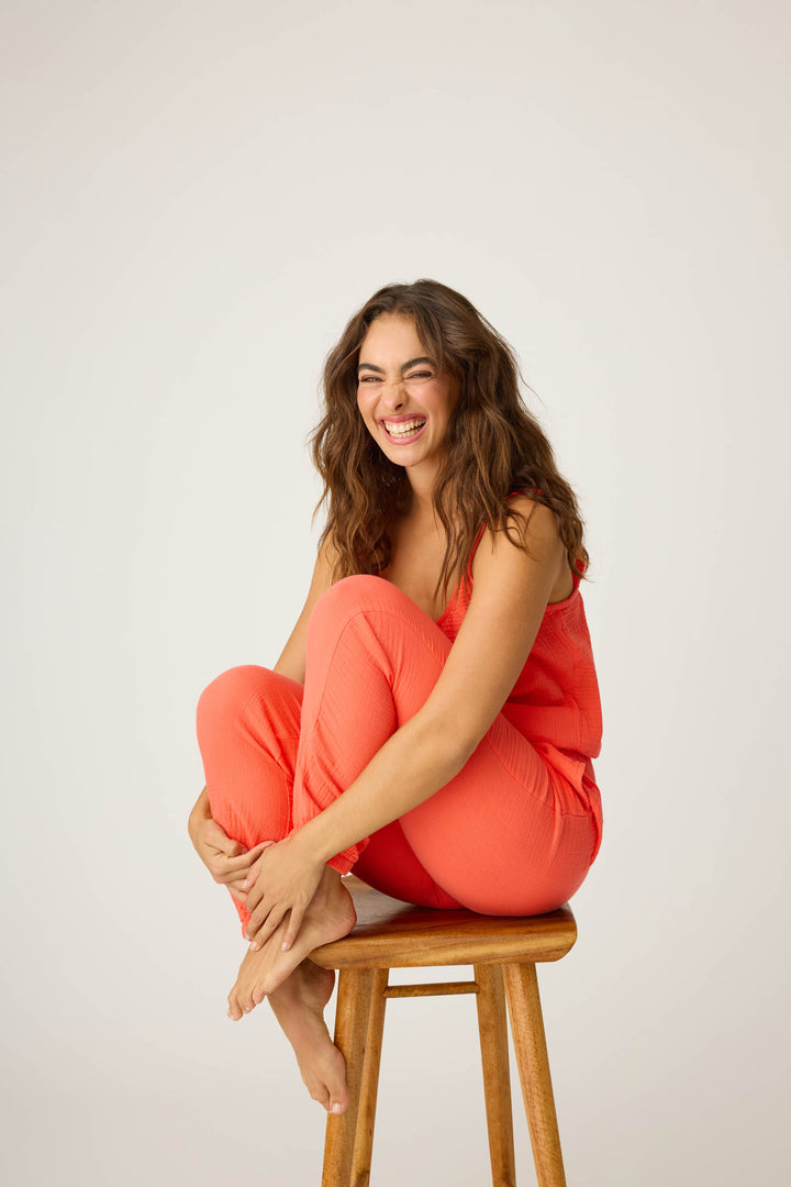 Women's red-orange lounge set top & pant in cotton woven gauze. Strappy camisole top & banded jogger styles.