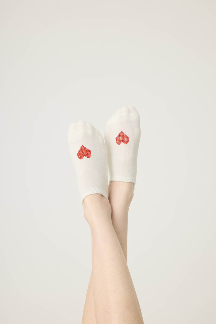 2-pack half-custhion liner socks. Women's & girls' socks in ivory with red heart & solid red, with non-skid grippers on sole.