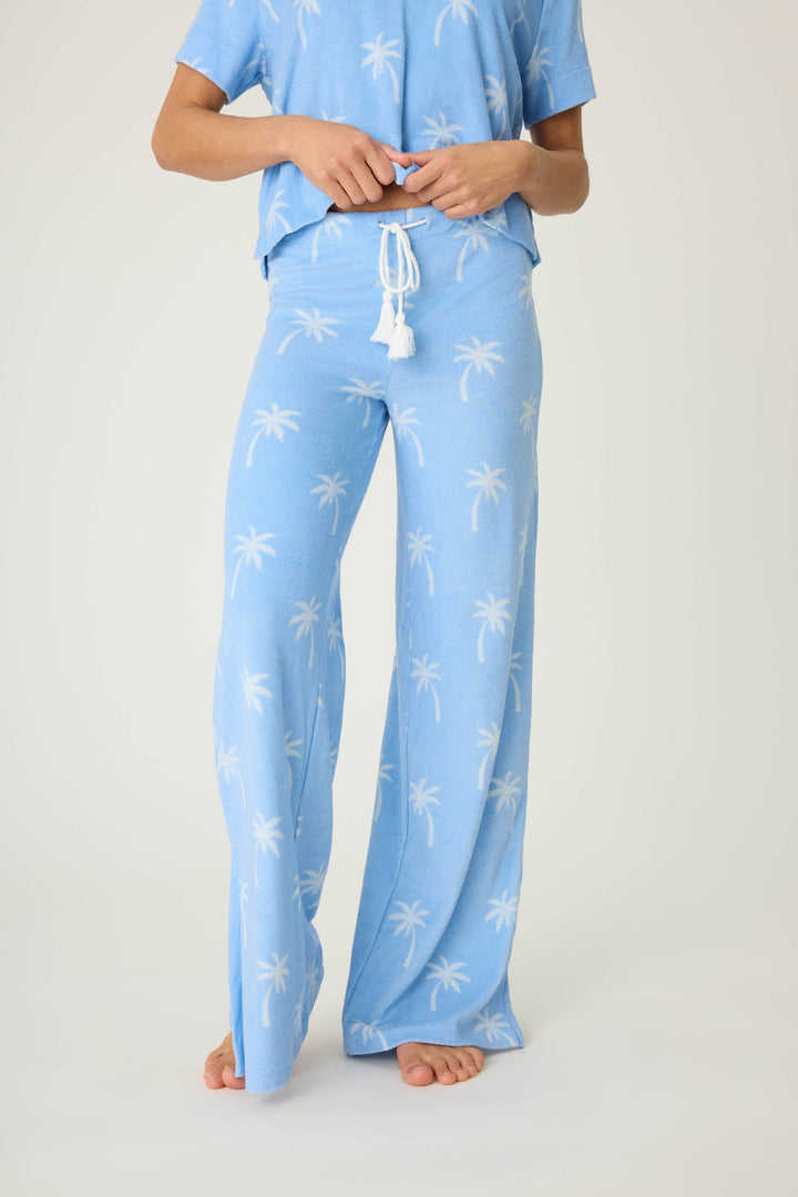 Women's blue palm-print lounge pant in vintage terry. Wide leg with side slits. Back patch pocket with tie waist.