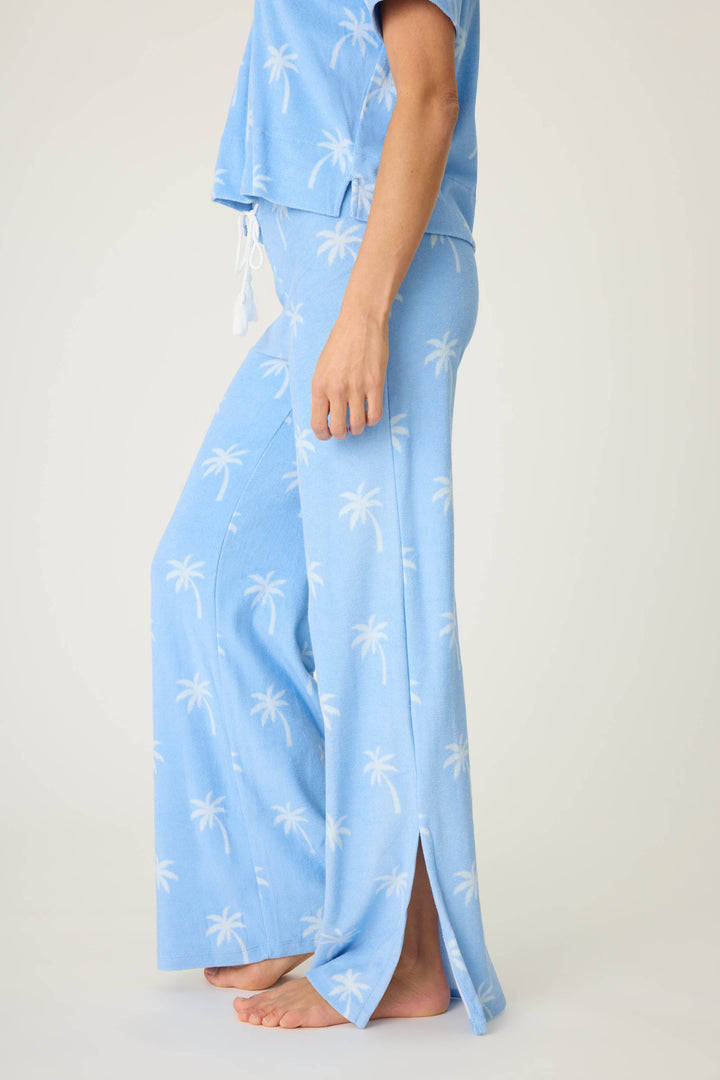 Women's blue palm-print lounge pant in vintage terry. Wide leg with side slits. Back patch pocket with tie waist.