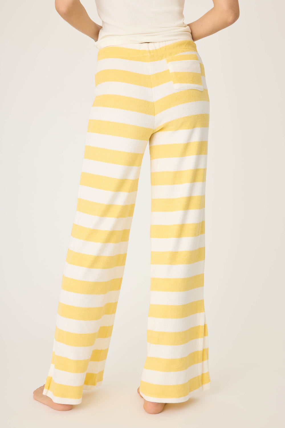 Ivory-yellow terry stripe pant for women. Wide leg with side slits. Back patch pocket with tie waist.
