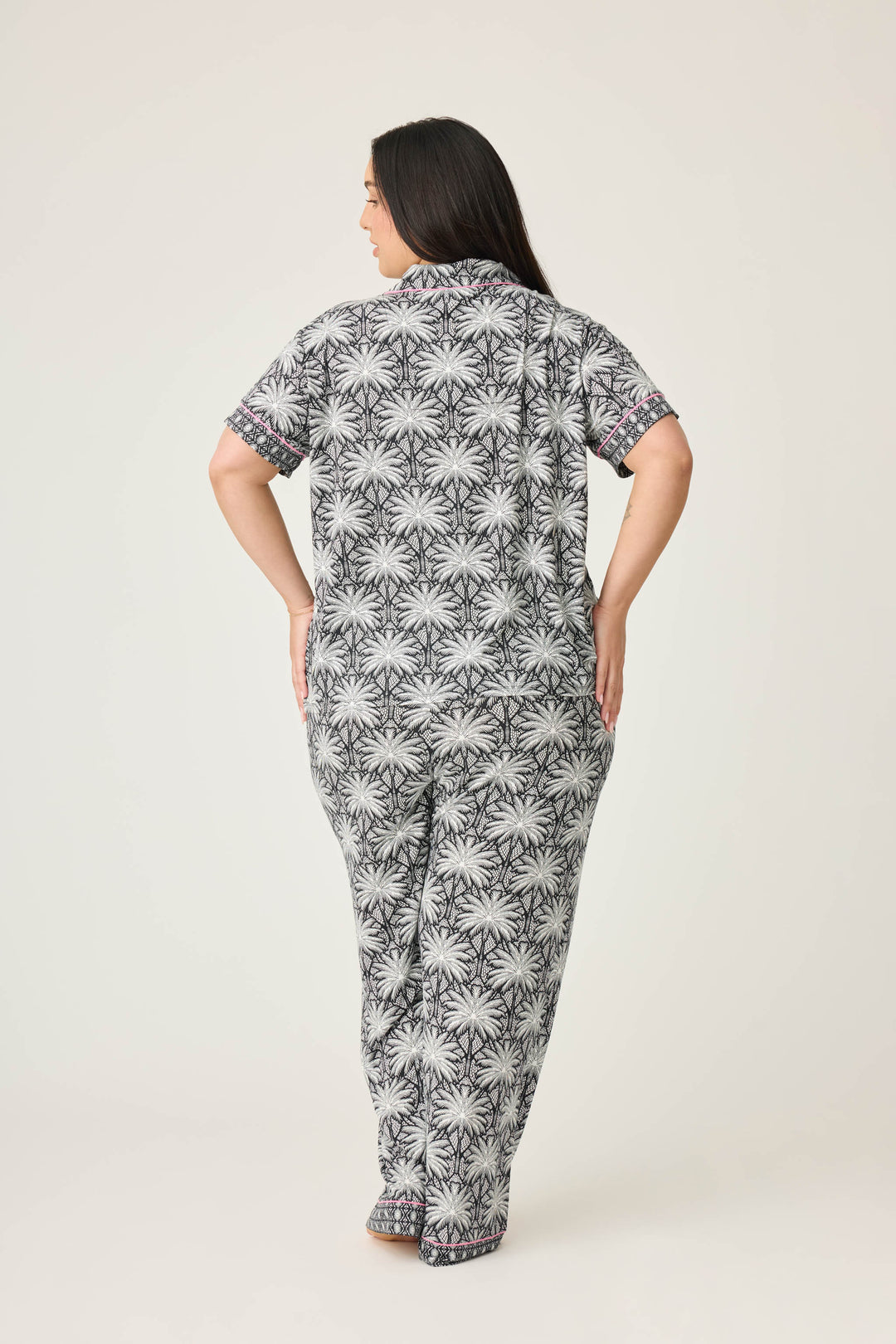 Women's black & ivory palm printed pajama set in modal. Short sleeve button-front top & pajama pant with contrast pink piping.