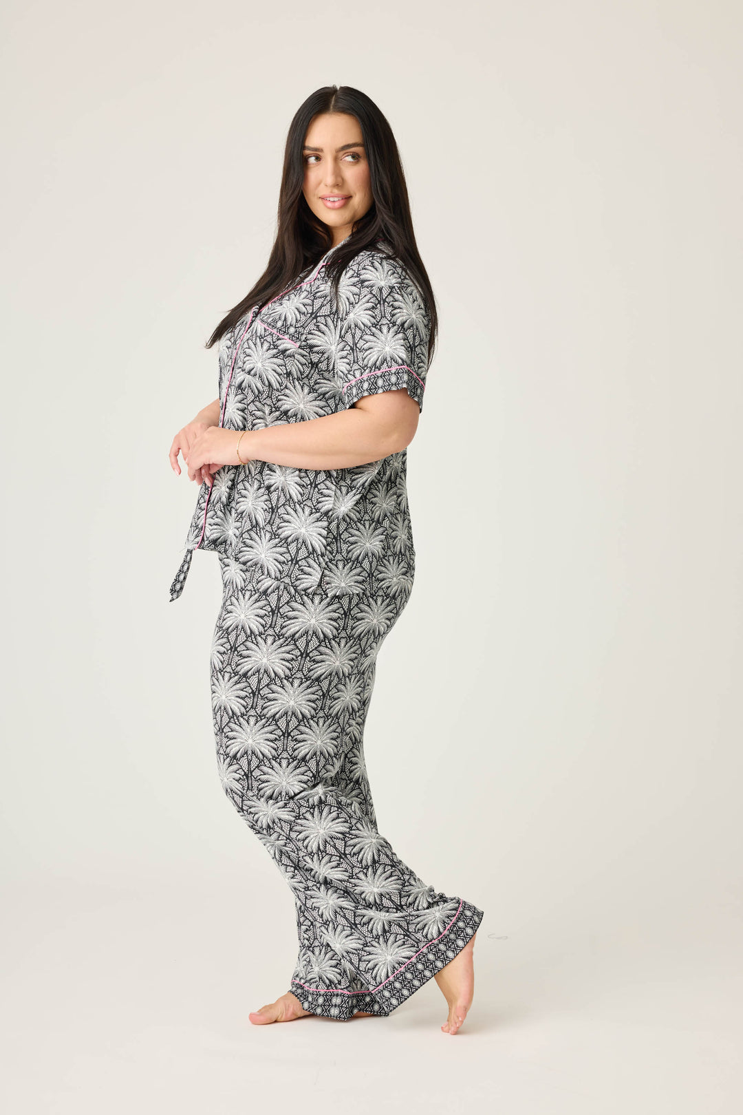 Women's black & ivory palm printed pajama set in modal. Short sleeve button-front top & pajama pant with contrast pink piping.