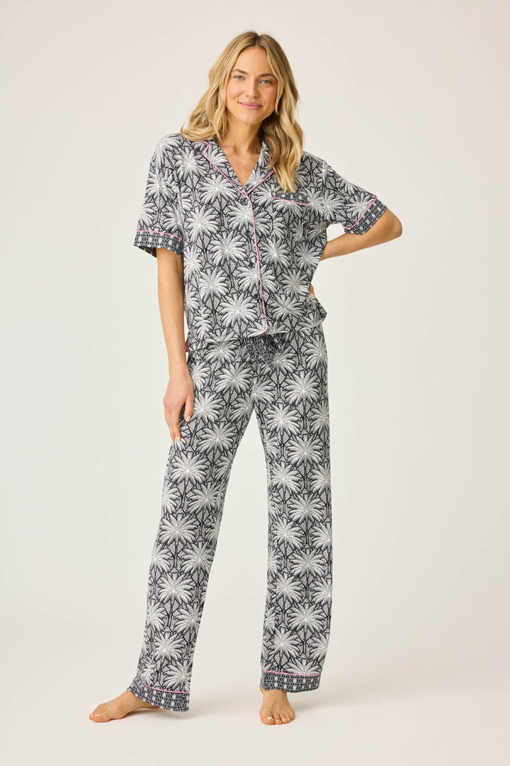 Women's black & ivory palm printed pajama set in modal. Short sleeve button-front top & pajama pant with contrast pink piping.