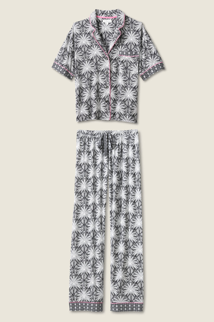 Women's black & ivory palm printed pajama set in modal. Short sleeve button-front top & pajama pant with contrast pink piping.