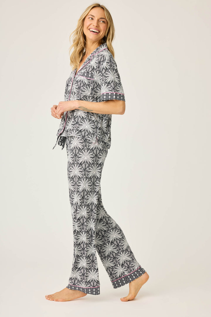 Women's black & ivory palm printed pajama set in modal. Short sleeve button-front top & pajama pant with contrast pink piping.