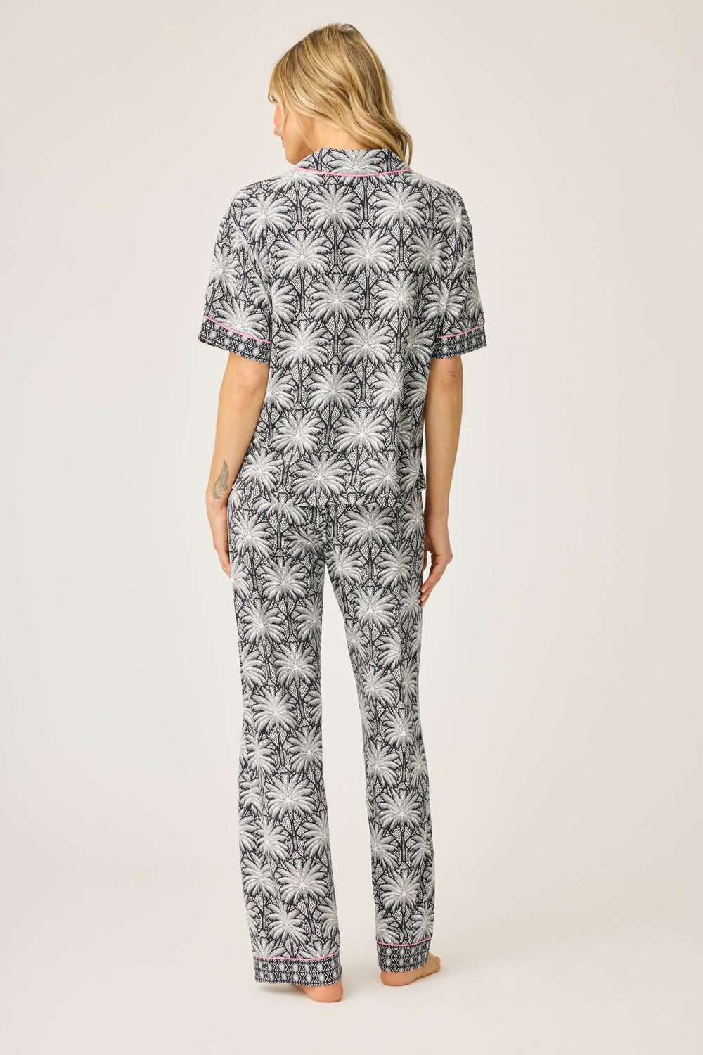 Women's black & ivory palm printed pajama set in modal. Short sleeve button-front top & pajama pant with contrast pink piping.