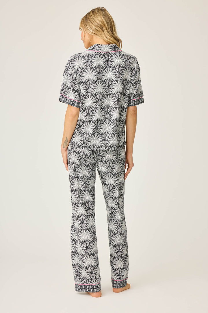 Women's black & ivory palm printed pajama set in modal. Short sleeve button-front top & pajama pant with contrast pink piping.