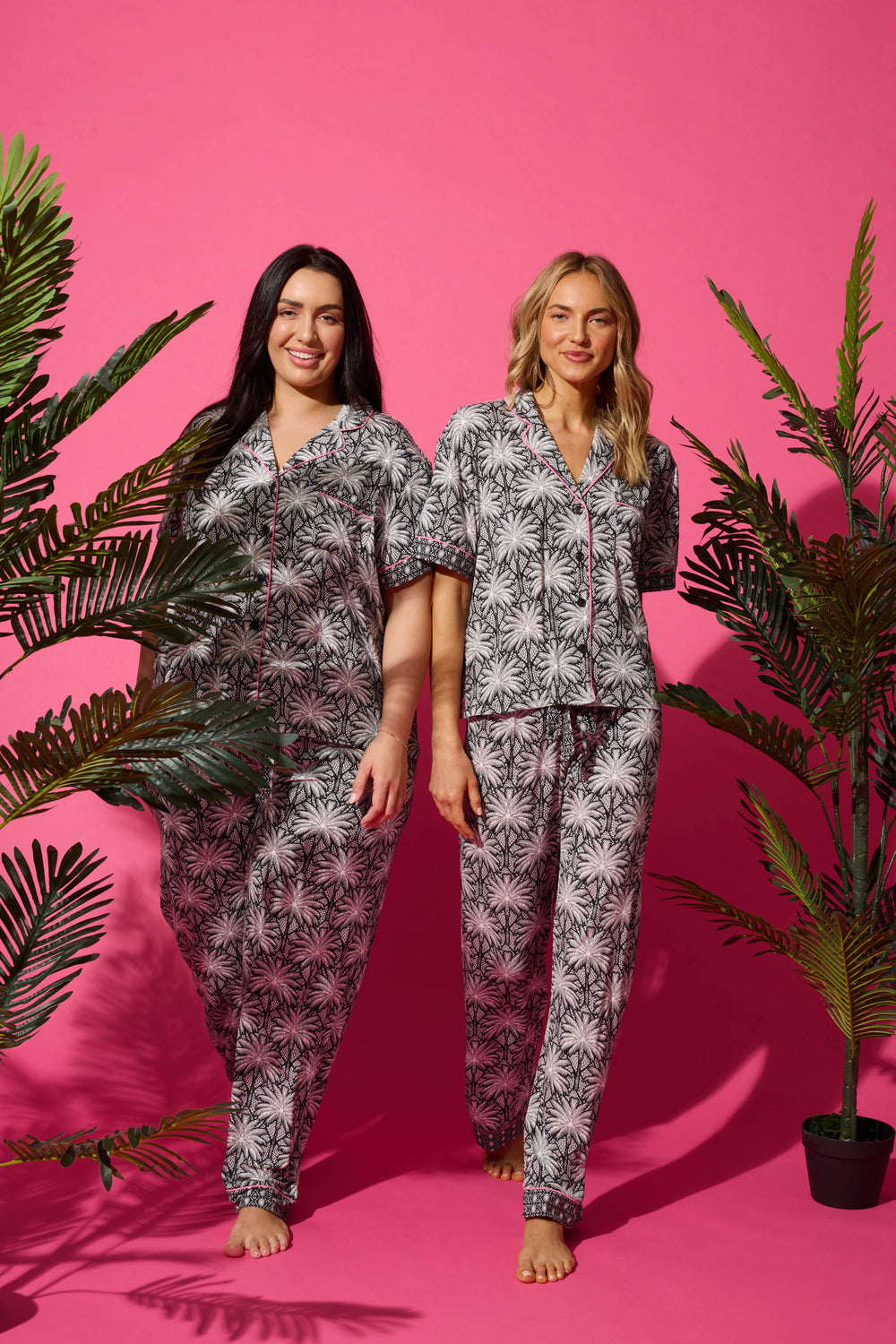 Women's black & ivory palm printed pajama set in modal. Short sleeve button-front top & pajama pant with contrast pink piping.