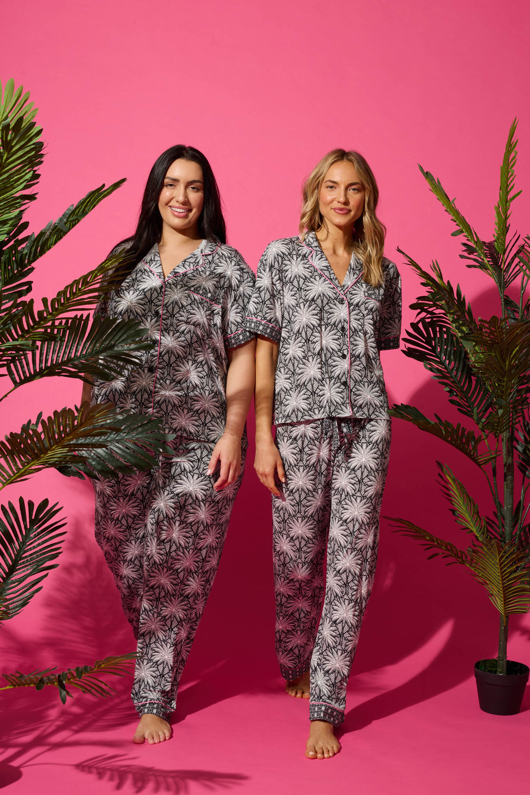 Women's black & ivory palm printed pajama set in modal. Short sleeve button-front top & pajama pant with contrast pink piping.