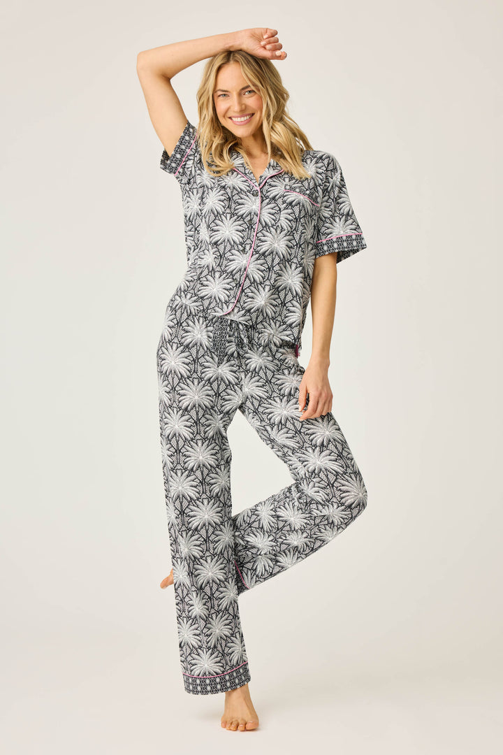 Women's black & ivory palm printed pajama set in modal. Short sleeve button-front top & pajama pant with contrast pink piping.
