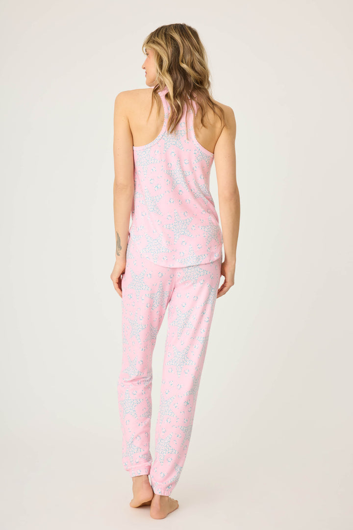 Women's pink & star print lounge set in peachy jersey. Racer back tank top with scallop edging & jogger pant with tie waist & pockets.