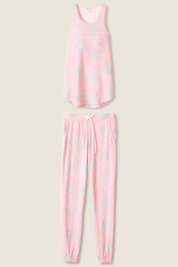 Women's pink & star print lounge set in peachy jersey. Racer back tank top with scallop edging & jogger pant with tie waist & pockets.