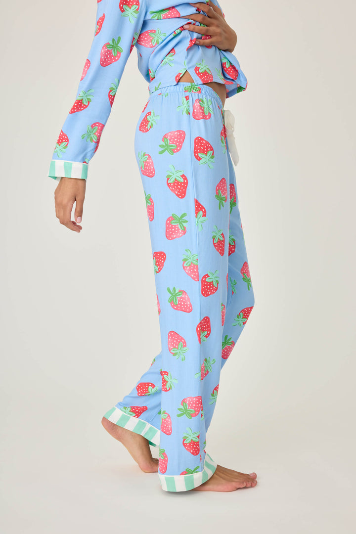 Women's pajama pant in blue with strawberry print in woven rayon sateen. Tie-waist in contrast stripe & striped cuffs.
