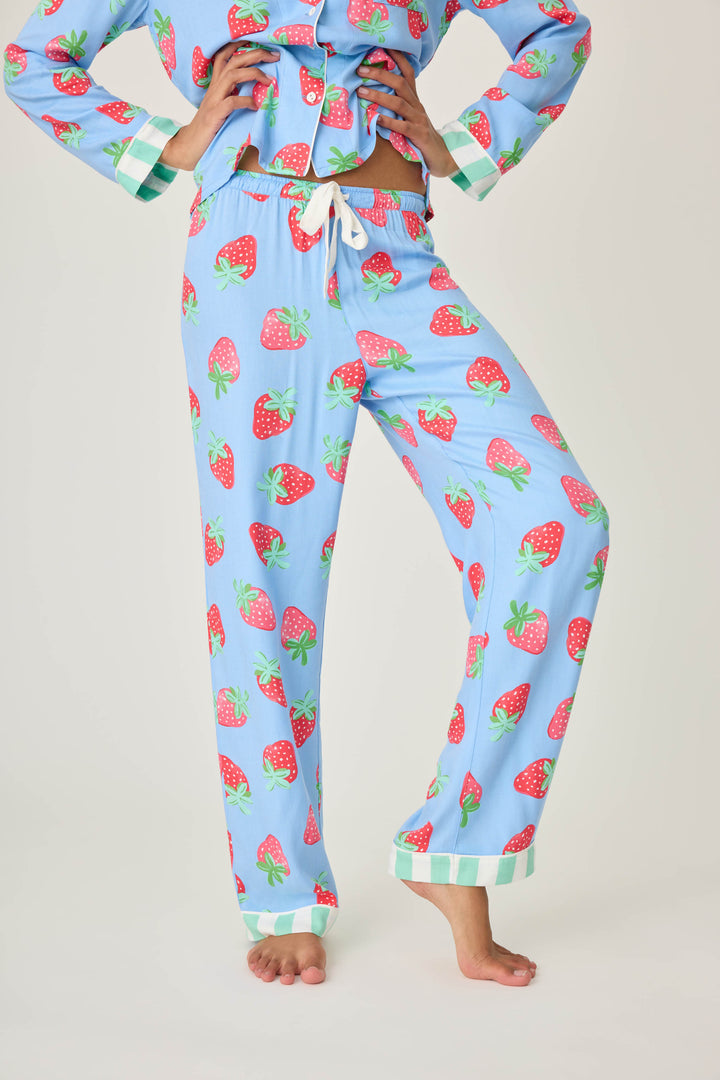 Women's pajama pant in blue with strawberry print in woven rayon sateen. Tie-waist in contrast stripe & striped cuffs.