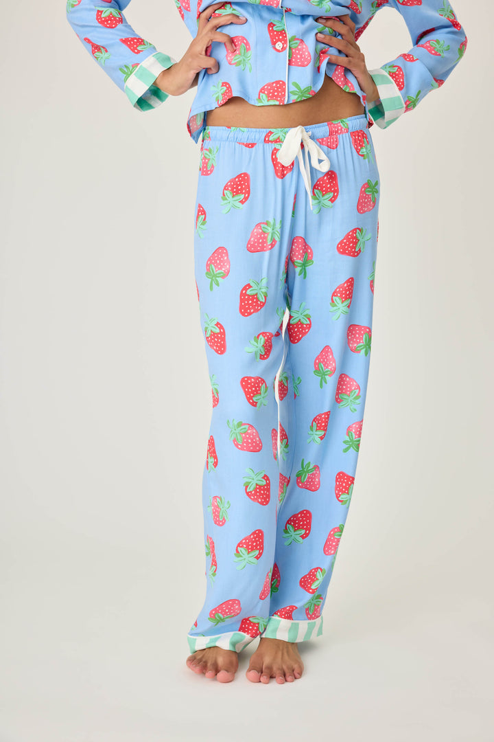 Women's pajama pant in blue with strawberry print in woven rayon sateen. Tie-waist in contrast stripe & striped cuffs.