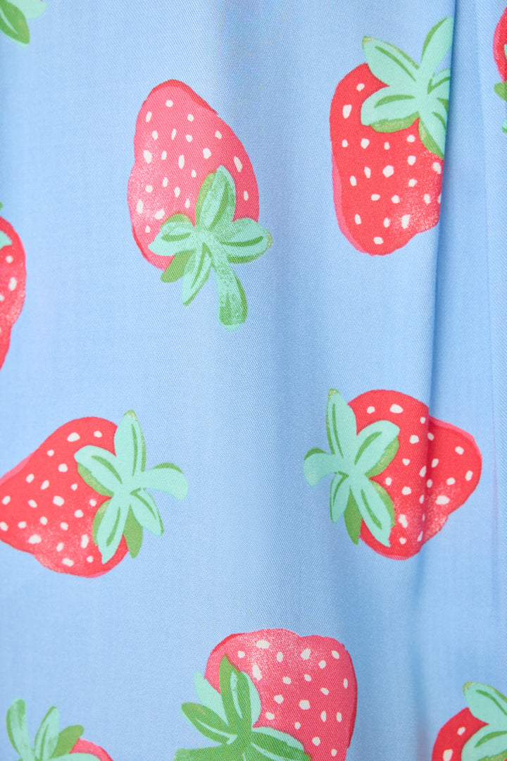Women's pajama pant in blue with strawberry print in woven rayon sateen. Tie-waist in contrast stripe & striped cuffs.