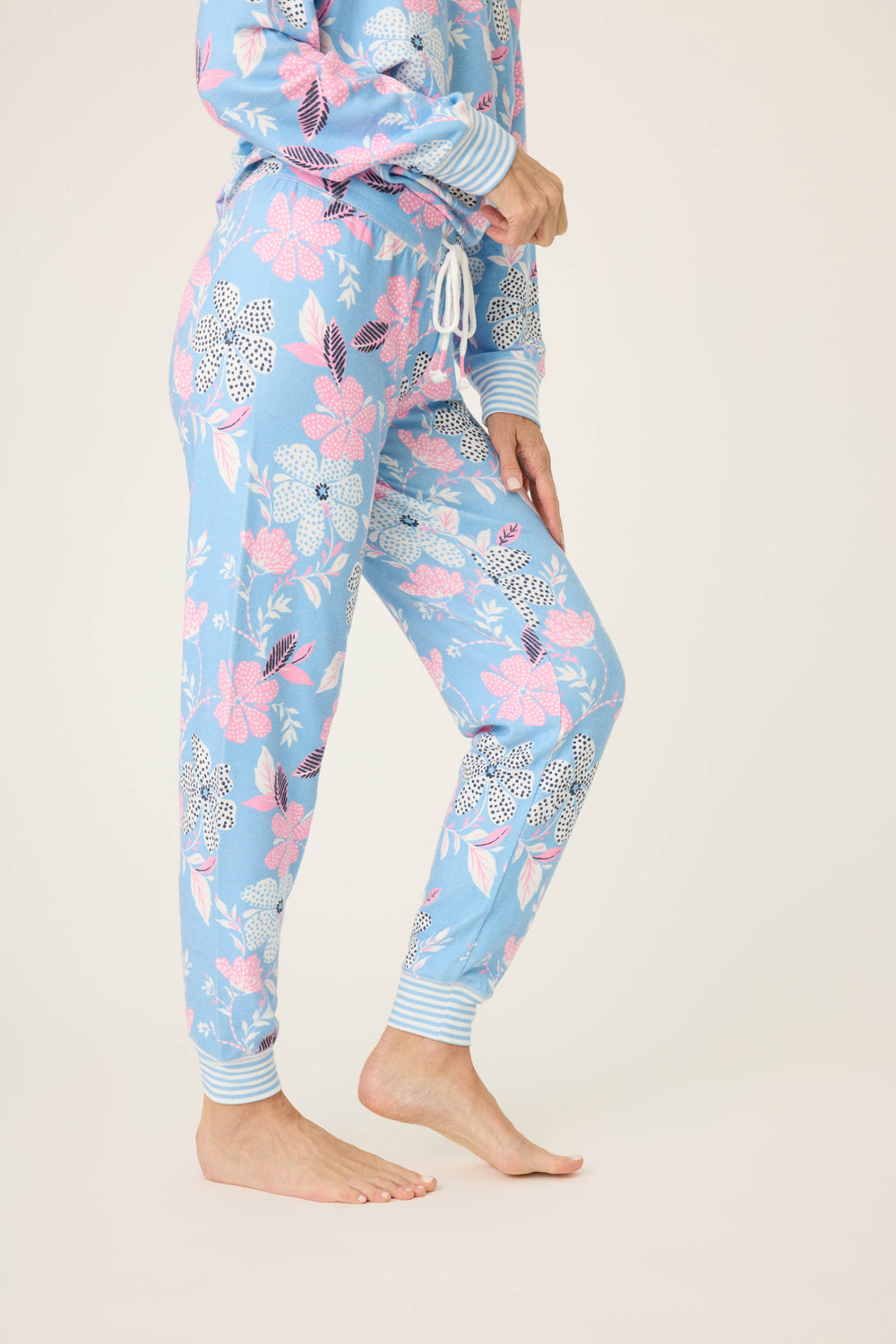 Women's ivory-blue-pink winter floral pj jogger with striped cuffs. Tie waist with faux 3-button fly.