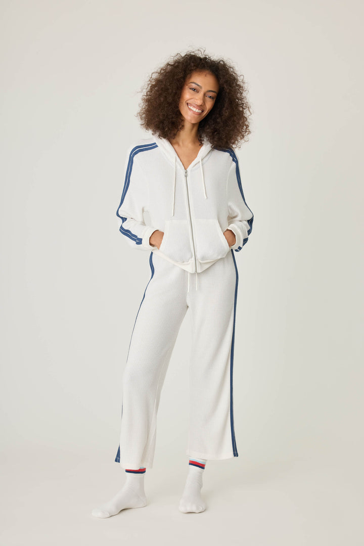 Women's ivory cropped lounge pant with navy athletic stripes on side. Tie waist.