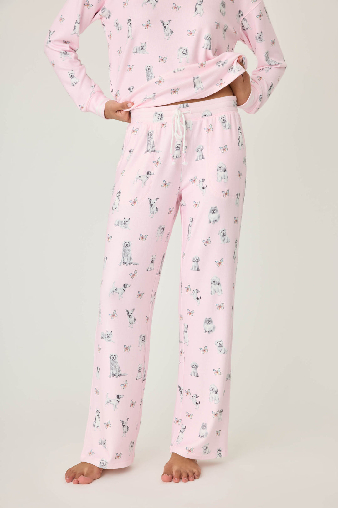 Pink dog-printed pajama pant for women with tie waist & side pockets.