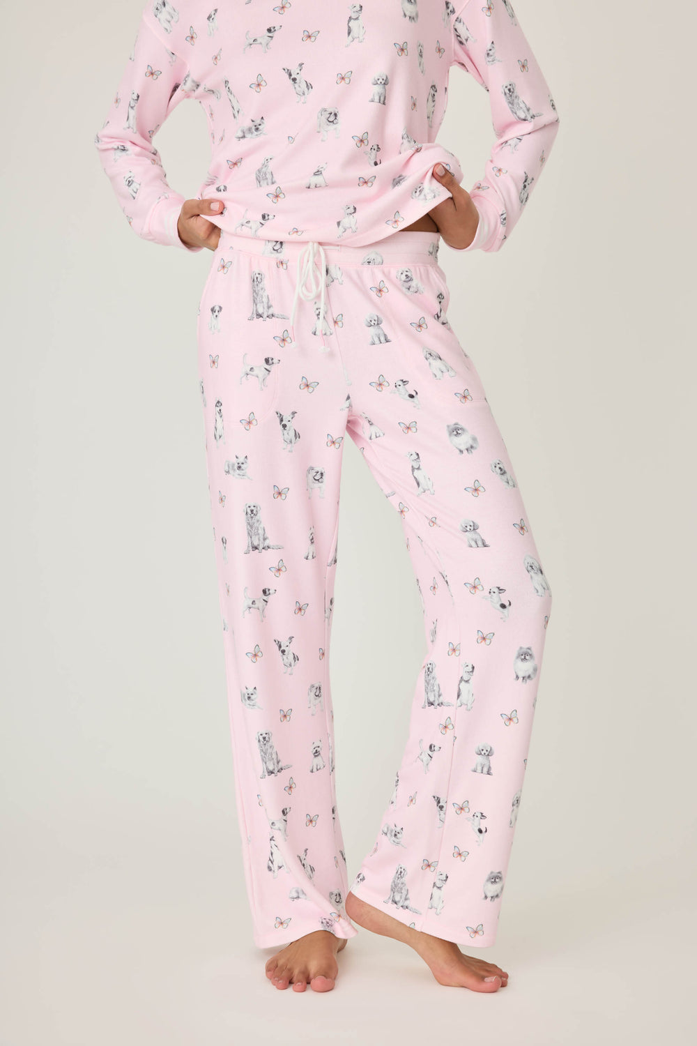 Pink dog-printed pajama pant for women with tie waist & side pockets.
