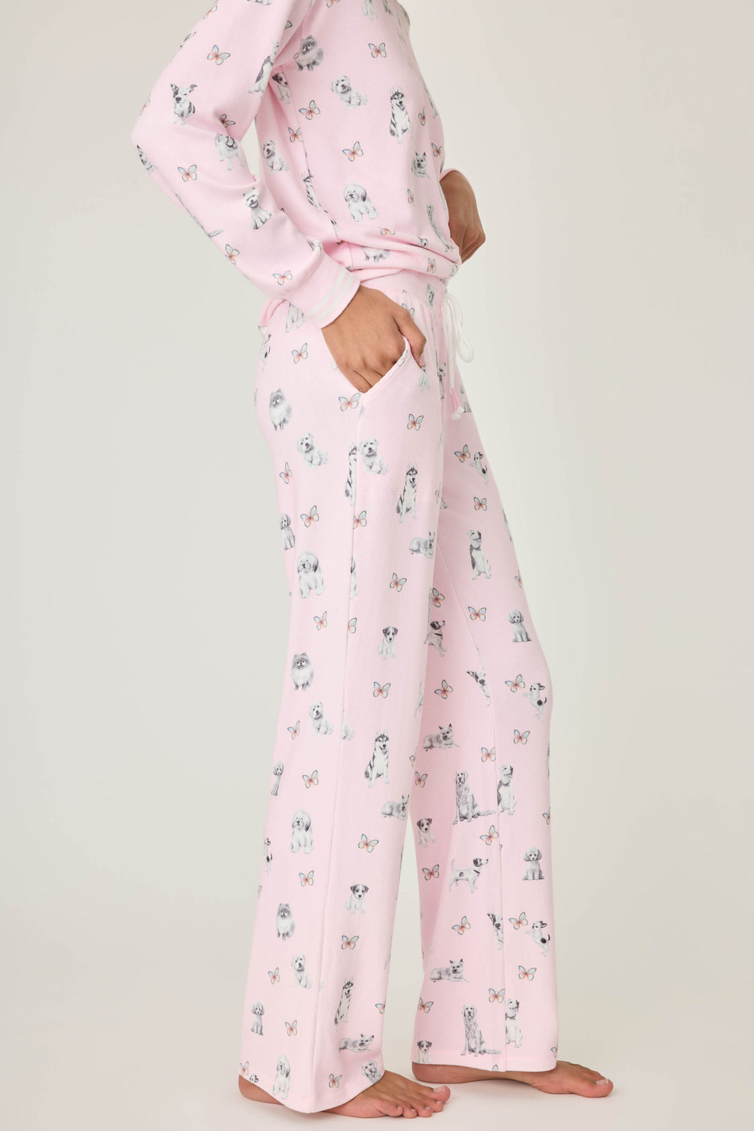 Pink dog-printed pajama pant for women with tie waist & side pockets.