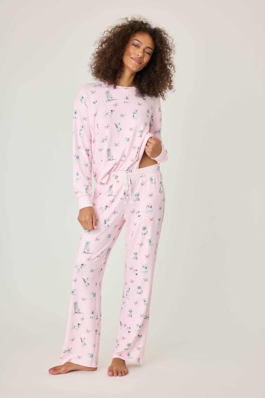 Pink dog-printed pajama pant for women with tie waist & side pockets.